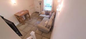 a living room with a couch and a table at LetAway - 16th Century Cottage in Richmond