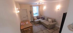 a living room with a couch and a table at LetAway - 16th Century Cottage in Richmond