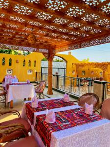 a dining room with tables and chairs and a roof at Jewel Howard Carter Hotel in Luxor