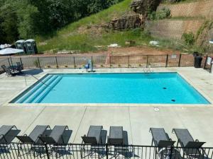 a large swimming pool with chairs at Near 76 Strip and SDC - King Beds - Outdoor Pool - FREE ATTRACTION TICKETS - V3301-6 in Branson