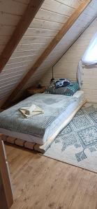 a bed in the attic of a room at Domek Skitnica in Mirsk