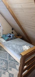 a bedroom with a bed in a attic at Domek Skitnica in Mirsk