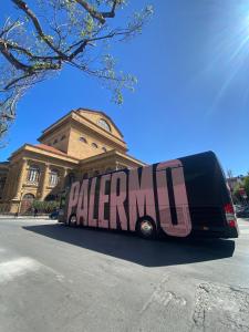 a bus is parked in front of a building at La Terrazza sul Massimo in Palermo