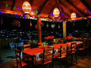 a restaurant with tables and chairs and lights at Casa Donaji in Oaxaca City