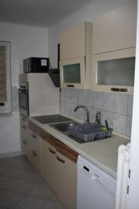 a kitchen with a sink and a counter top at in a quiet location - Schwanewede in Schwanewede