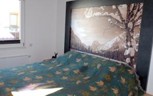 a bedroom with a large painting on the wall at Luxury Eco-Chalet Pino Achensee - hike, bike, ski for 6 or more in Achenkirch