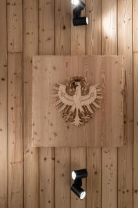 a wooden wall with an eagle sign on it at Luxury Eco-Chalet Pino Achensee ski-in ski-out for 6 or more in Achenkirch