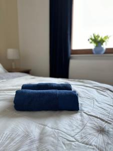 two blue towels sitting on top of a bed at Apartament Jasna Góra in Częstochowa