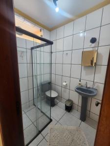 een kleine badkamer met een wastafel en een toilet bij Flat MP Pluma in Araxá