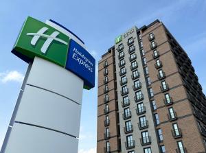 a hotel sign in front of a tall building at Holiday Inn Express - Ankara - Airport by IHG in Ankara