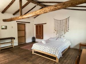 a bedroom with a bed and a wooden floor at Casona Don Giovanni in Lamay