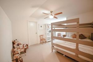 a bedroom with a bunk bed and a ceiling fan at Stunning Crafers Villa amongst the beautiful hills in Crafers