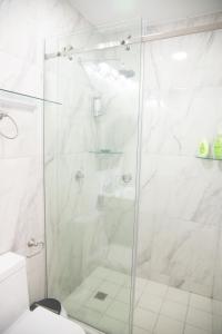 um chuveiro com uma porta de vidro na casa de banho em Apartamento en Panamá Céntrico y lujoso en Panamá de la zona Bancaria na Cidade do Panamá