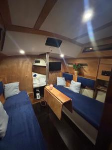 a room with two beds and a table in a boat at LA REGINA in Lido di Ostia