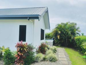 a white house with a pathway leading to it at Harmonious Bella Villa in Pacific Harbour