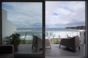 a view of the ocean from a room with a sliding glass door at Casa Da Praia in Porto Formoso