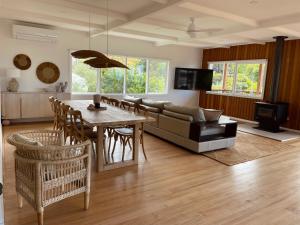 a living room with a couch and a table at The Dunes *Beachfront* Lake Tyers Beach in Lake Tyers