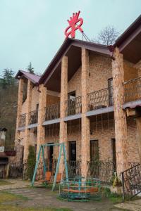 a large brick building with a playground in front of it at Royal Rest Townhouse in Dilijan