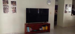 TV de pantalla plana en la parte superior de un soporte de madera en Maria e Nicola, en Jarabacoa