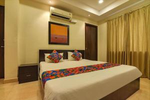a bedroom with a large bed in a room at Hotel Ramakrishna unit by AMBIENCE New Delhi in New Delhi