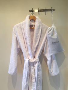 a white robe is hanging on a hanger at Brooklands in Tavistock