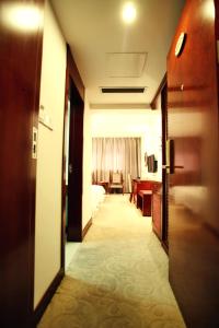 a hallway of a hotel room with a bedroom at Tianxinglou Hotel in Nanjing