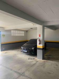 a car is parked in a parking garage at Piemonte Flat Serra Negra in Serra Negra