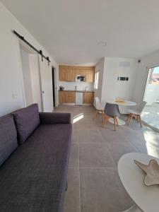 a living room with a couch and a table at Hoy Caleta Apartments in Caleta De Fuste