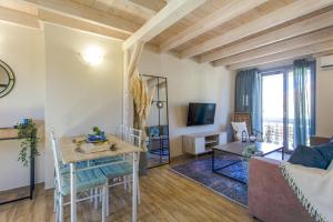 a living room with a table and a couch at Ocean Breeze Kassiopi in Kassiopi