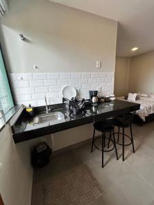 a kitchen counter with a sink and a bed at Morada do Sol Suítes in Arraial do Cabo +77 photos