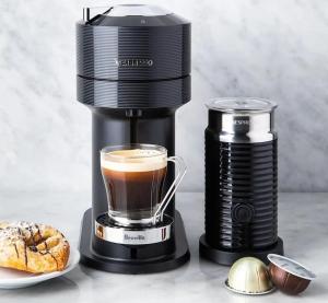 a coffee maker with a cup of coffee and a pastry at Vouliagmeni Garden Suite by Astir beach in Athens