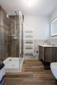 a bathroom with a tub and a toilet and a sink at Radnoti Home in Veszprém