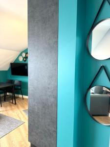 a room with a blue wall and a mirror at Apartamento Sálvora in Vilagarcia de Arousa