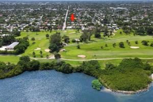 an aerial view of a golf course with a red flag at Sabal Palm Vacation Homes in Lake Worth