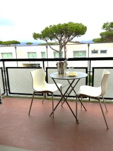 a table and two chairs on a balcony at Lara's Apartment in Lido di Camaiore