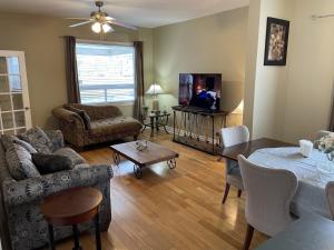 a living room with a couch and a table at Tranquility near the River Complimentary Breakfast in Niagara Falls