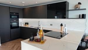 a kitchen with black cabinets and a white counter top at Sea Garden Ramsgate Sleeps4 Parking Amazing Views in Ramsgate