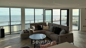 a living room with a couch and a view of the ocean at Sea Garden Ramsgate Sleeps4 Parking Amazing Views in Ramsgate