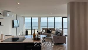 a kitchen and living room with a view of the ocean at Sea Garden Ramsgate Sleeps4 Parking Amazing Views in Ramsgate