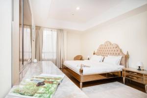 a white bedroom with a large bed and a window at Get Rooftop Pool at 2BR APT Near Mall Of Emirates 411 in Dubai