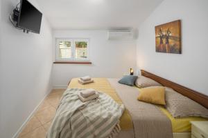 Posteľ alebo postele v izbe v ubytovaní Guest House Ravnić