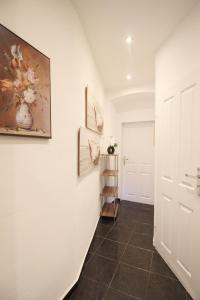 a hallway with a painting of flowers on the wall at 23Sam Apartment vienna in Vienna
