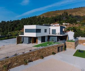 a large white house on top of a hill at Douro - Quinta das Manas - Baião in Alcarias