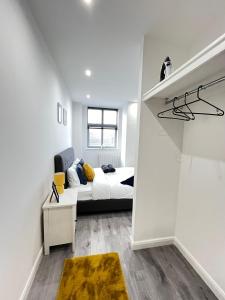 a bedroom with a bed in a white room at Leicester City Centre Flat in Leicester