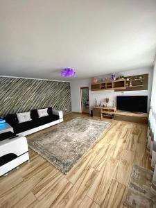 a living room with a couch and a television at Casa Dutu in Tuzla