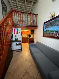 a living room with a couch and a staircase at Old San Juan Historic Loft 4 The Adventurous in San Juan