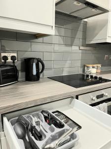 a kitchen with a counter top with a drawer at Leicester City Centre Flat in Leicester