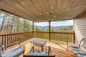 a screened in porch with a table and chairs on it at Stairway to Heaven in Townsend