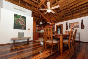 a dining room with a wooden table and chairs at Pur Private Suites in San Pedro
