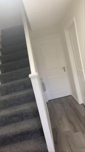 a stairway with a stair case in a house at Cute 2 bedroom house Littleover close to amenities hospital in Derby